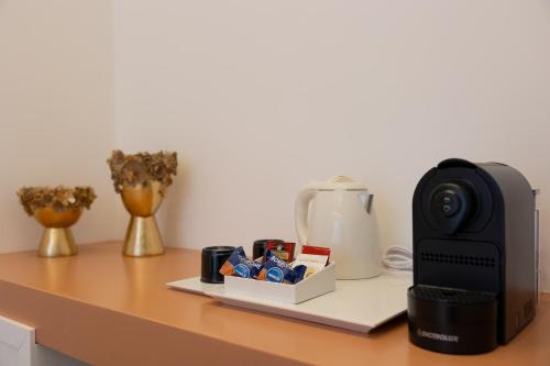 a counter top with a coffee maker and a coffeeeper at Radici Tropea in Tropea