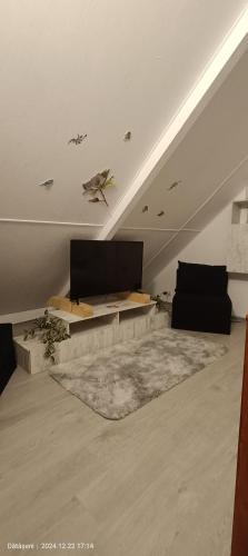 a living room with a couch and a table at Sunset Oasis in Dătăşeni