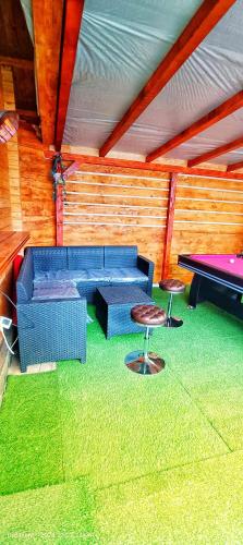 a living room with couches and a pool table at Sunset Oasis in Dătăşeni
