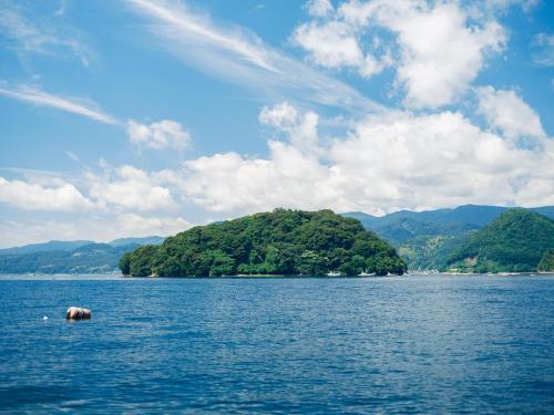 an island in the middle of a large body of water at Funaya Raku 樂 in Kameshima
