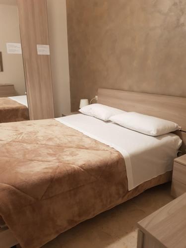 a bedroom with a large bed with white pillows at la casa al mare in Pescara