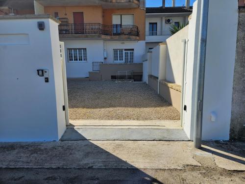 an open door to a yard with a house at Villetta Relax in Taurisano