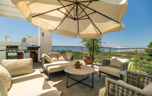 a patio with a table and a large umbrella at Casa Per in Marbella