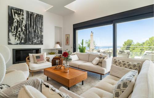 a living room with white furniture and a large window at Casa Per in Marbella