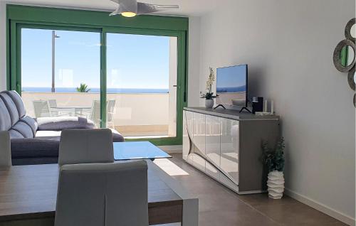 a living room with a couch and a tv at Casa Cantal in Mojácar