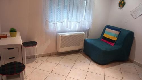 a room with a chair and an air conditioner at Fenyves Villa in Balatonfenyves