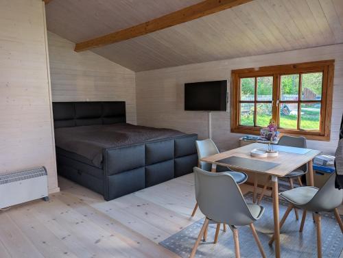 a bedroom with a bed and a table and chairs at Ferienhaus am See Wutzsee mit direktem Seezugang in Lindow