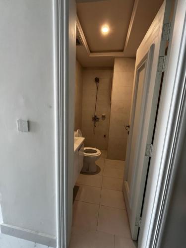 a bathroom with a toilet and a sink at Effile view studio apartment in Lahore