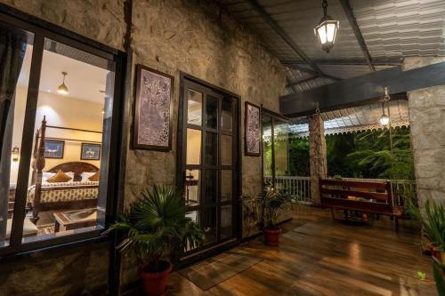 a living room with plants and a stone wall at Jawai Greens in Jawāi Bāndh