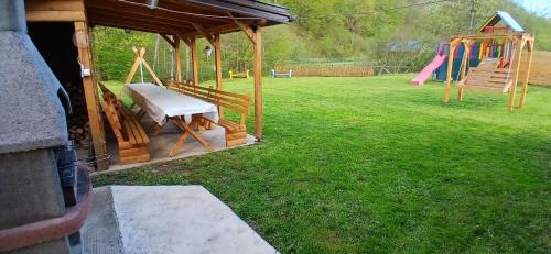 a playground with a slide and a swing at VIKENDICA NOLE Jahorina in Pale