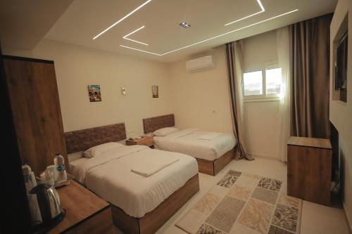 a hotel room with two beds and a window at The View Pyramids Gold Two in Cairo