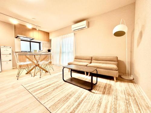 a living room with a couch and a table at F Hotel 新築アパート 近くに品川と羽田空港 无料駐車場予約必須 in Tokyo