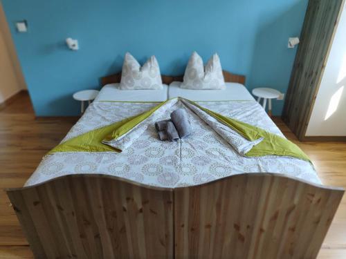 a bed with a stuffed animal on top of it at Velocipéd Vendégház in Balatonudvari