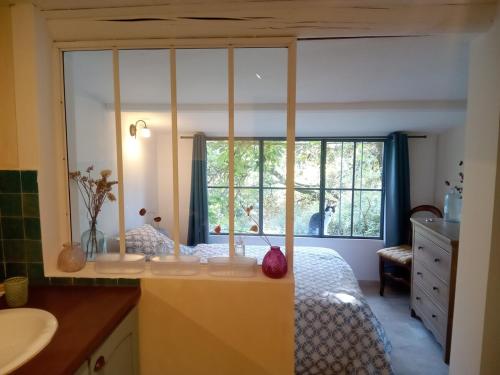 une chambre avec un lit et une fenêtre dans l'établissement Mazet terrasse et jardin Nîmes, à Nîmes