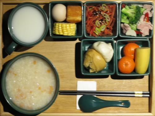 a tray of food with a bowl of soup and vegetables at 九寨沟碧家小筑民宿 Bijia Boutique B&B, jiuzhaigou in Tazang