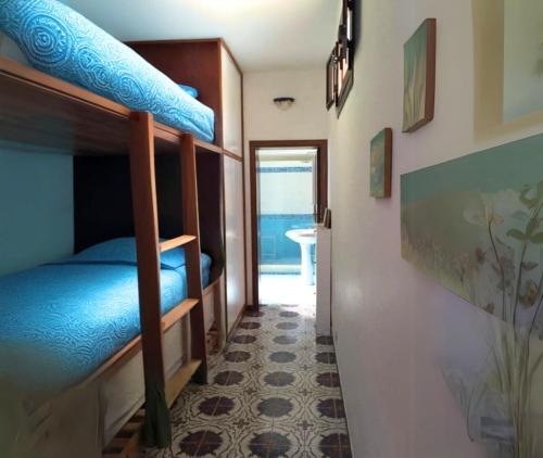 a room with two bunk beds and a hallway at Casa Platamone 2 in San Vito lo Capo