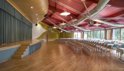 a large room with chairs and tables in it at Vivea Gesundheitshotel Bad Häring in Bad Häring