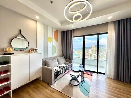 a living room with a couch and a table at TMS Quy Nhơn - Hupa Apartment View Biển in Quy Nhon