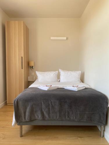 a bedroom with a large bed with two pillows at U Aktorów - Pokoje Gościnne in Elblag