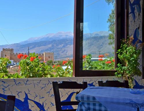 a table and chairs with a view of the mountains at Orthi Ammos in Frangokastello