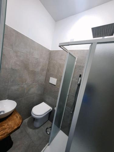 a bathroom with a toilet and a shower stall at Casa Siria in Livorno