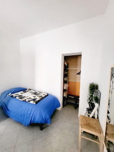 a bedroom with a bed with a blue comforter at Casa Siria in Livorno