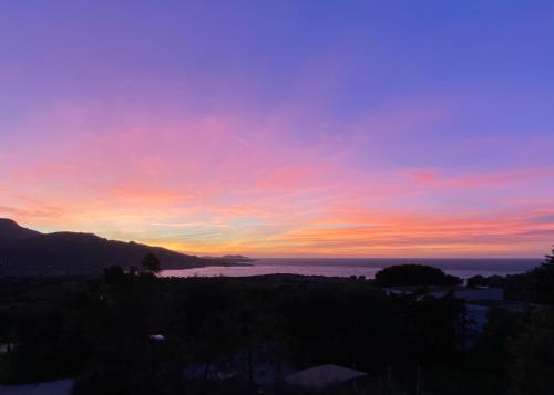 a sunset over a body of water at Hotel L'ondine in Algajola