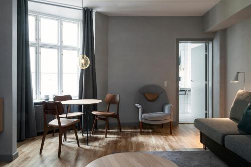 a living room with a table and chairs at Hotel SP34 in Copenhagen