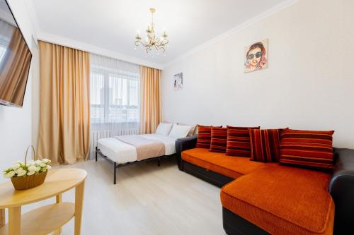 a living room with a couch and a bed at Luxury 3 Bed Room Apartment Near Baiterek in Astana