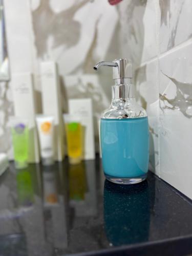 a bottle of blue soap sitting on a counter at Sapphire holiday homes in Ras al Khaimah