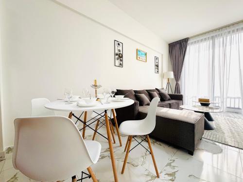 a living room with a couch and a table and chairs at Sapphire holiday homes in Ras al Khaimah