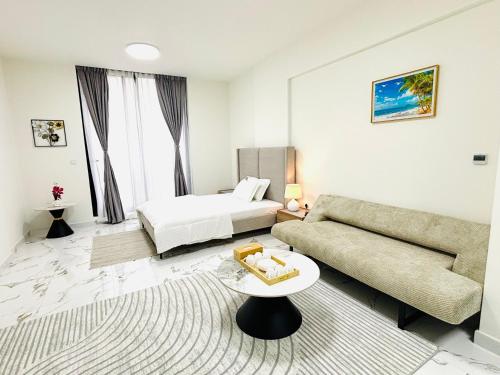 a living room with a couch and a bed at Sapphire holiday homes in Ras al Khaimah