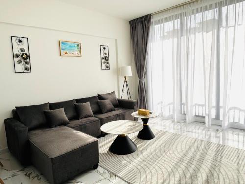 a living room with a couch and a table at Sapphire holiday homes in Ras al Khaimah
