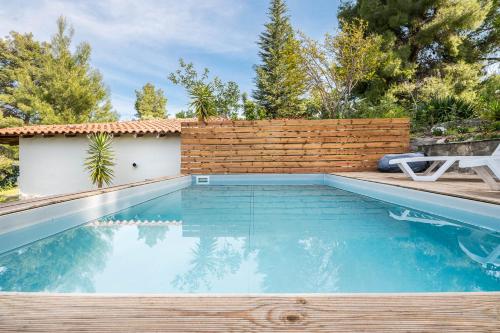 a swimming pool in a backyard with a brick wall at Melora Mare 2 Bedroom Villa Private Pool in Paliouri