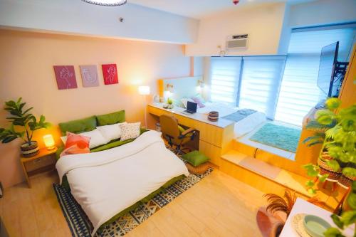 a room with a bed and a desk in it at Free Parking Promo! Eastwood LeGrand 3 - Mowai Suites in Manila