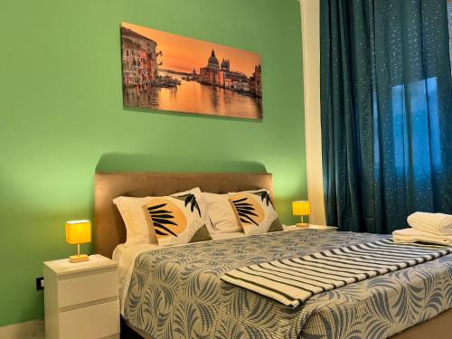a bedroom with a bed with two lamps and a painting at United Residence in Venice