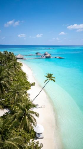 a view of a beach with palm trees and the ocean at Sirru Fen Fushi Private Lagoon Resort Maldives in Shaviyani Atoll