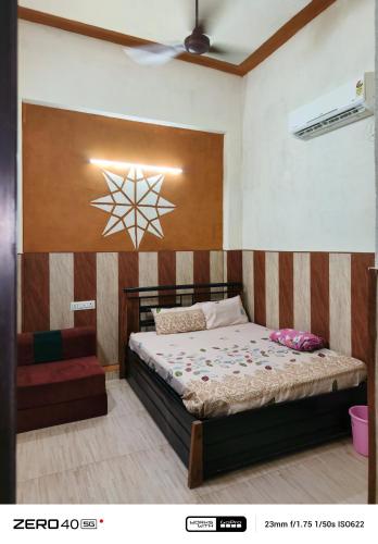 a bedroom with a bed with a star on the wall at SIDHU GUEST HOUES -400 walking distance From golden Temple in Amritsar