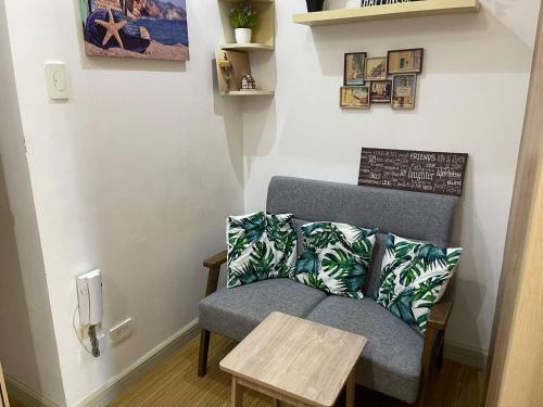 a living room with a chair and a table at SMDC GRACE RESIDENCIES in Manila
