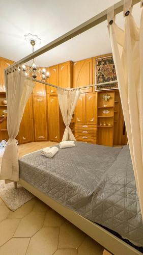 a bedroom with a canopy bed with wooden cabinets at Pantheon Luxury Noble Apartment in Rome