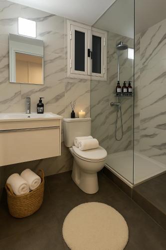a bathroom with a toilet and a shower and a sink at Studio by The Sea in Limassol