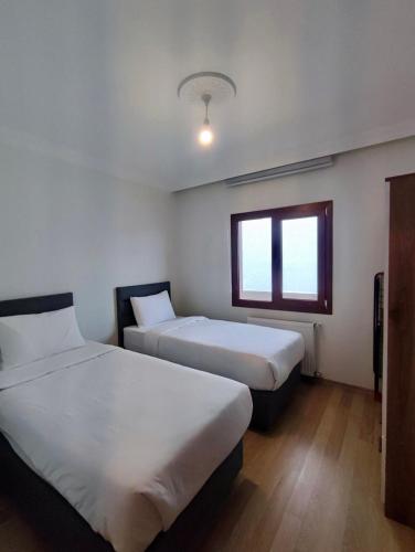 Ένα ή περισσότερα κρεβάτια σε δωμάτιο στο Erom Otel
