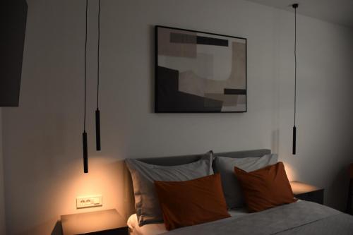 a bedroom with a bed and a picture on the wall at Villa Maksan - Sea View, Jacuzzi & BBQ Garden in Pakoštane