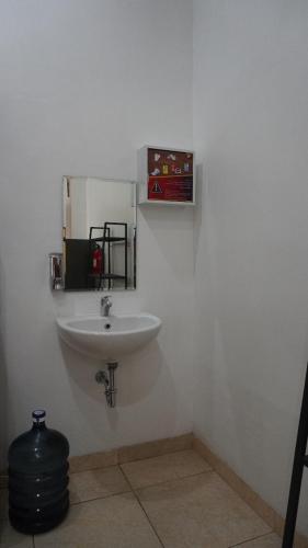 a bathroom with a white sink in a room at Diyar Villas Puncak M6/14 in Puncak