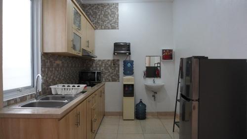 a kitchen with a sink and a refrigerator at Diyar Villas Puncak M6/14 in Puncak