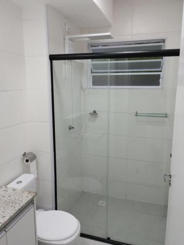 a bathroom with a glass shower with a toilet at Aconchego de Espírito Santo do Pinhal in Espirito Santo Do Pinhal
