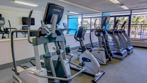 a gym with treadmills and elliptical machines at Oceanview Condo Pool Steps to Beach Hot Tubs in Myrtle Beach