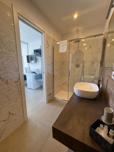 a bathroom with a bath tub and a shower at Orizzonte Mare Panoramic Rooms in Agropoli