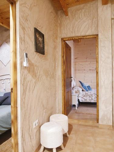 a room with two white stools and a bedroom at Casa Estrella in Villafamés
