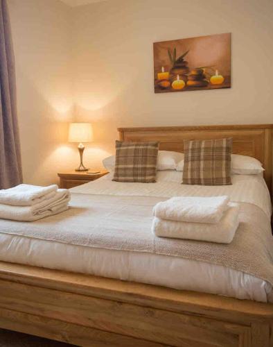 a bedroom with a bed with two towels on it at Ardmore Holiday Cottage in Trumpan